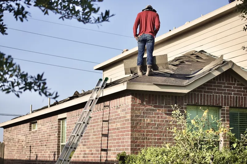Professional roofer working on a residential roof in Bennington Springs